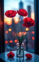 Red poppies in a vase against a sunset backdrop. A grouped arrangement of red poppies stands in a jar, with a vibrant sunset city view in the background. photo