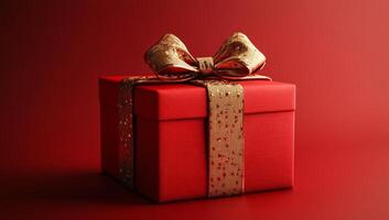 Red gift box with gold ribbon on red. A red gift box with a golden bow against a matching backdrop, ideal for celebrations. photo