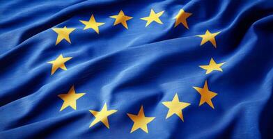 A blue and yellow flag with a star pattern. The flag is from Europe. The flag is waving in the wind photo