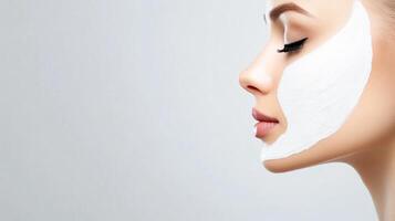 A woman with a white face mask on. The woman has a very clean and fresh look. The white face mask is covering her face, giving her a glowing and youthful appearance photo