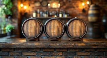 Three wooden barrels are on a wooden counter in front of a brick wall. The barrels are empty and the counter is made of wood photo