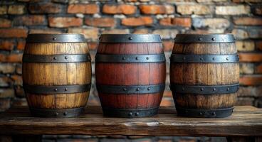 Three wooden barrels are lined up on a wooden table. The barrels are of different colors, with one being brown, one being red, and one being black. Concept of rustic charm and warmth photo