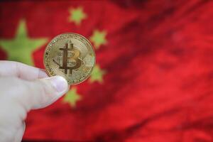 Bitcoin golden coin with China flag in the background photo