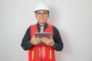Portrait of a handsome chief engineer wearing a hard hat. Wearing a reflection tiger holding a notepad with thumbs up isolated on a white background clipping path. photo
