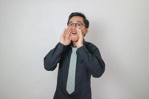 Asian office man wearing black shirt is showing shouting expression, office man concept photo
