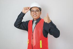 Confident engineer handsome man thumbs up at modern home building construction. Architect looking camera with white safety helmet at construction site. photo