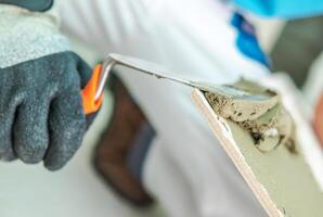 Worker Applying Plaster With a Trowel During Renovation in a Home Interior photo