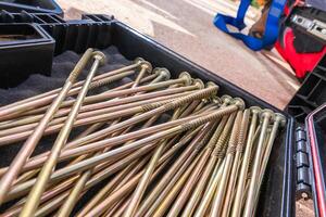 Long Metal Screws Arranged Neatly in a Toolbox During a Construction Project photo