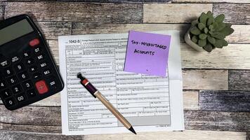 Concept of Tax-Advantaged Accounts write on sticky notes isolated on Wooden Table. photo