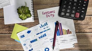 Concept of Customs Duty write on sticky notes isolated on Wooden Table. photo
