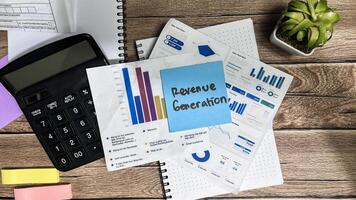 Concept of Revenue Generation write on sticky notes isolated on Wooden Table. photo
