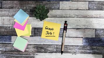Concept of Great Job write on sticky notes isolated on Wooden Table. photo
