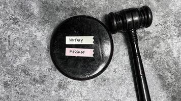 Concept of Notary Message write on sticky notes isolated on Wooden Table. photo