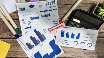 Concept of Sales Metrics write on sticky notes isolated on Wooden Table. photo