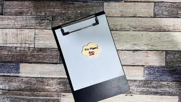 Concept of No Means, No write on sticky notes isolated on Wooden Table. photo