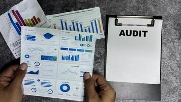 Concept of Audit write on paperwork isolated on Wooden Table. photo