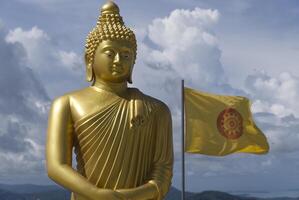 The Golden Buddha Statues over a cloudy sky photo
