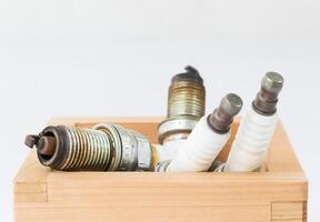 Spark plug in wood box photo