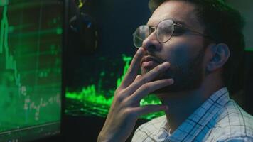 Thoughtful pensive Arabian Indian man thinking pondering solution programmer coder hacker worker cyberspace analysis male guy puzzled trader broker freelancer doubtful face online engineer developer video