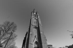 A tall church with a clock tower in the background photo