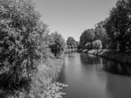 Black and white photo of a river in a park