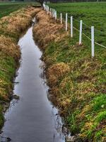 A small stream running through a field photo