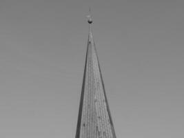 A black and white photo of a steeple