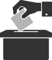 A grayscale icon depicts a hand dropping a ballot into a ballot box. Simple, symbolic representation of voting and elections. vector
