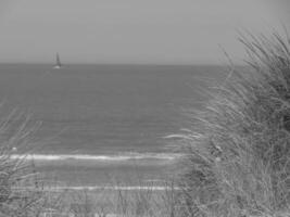 A sailboat is out in the ocean photo
