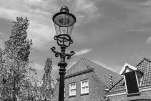 A black and white photo of a street lamp