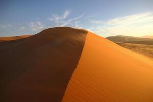 Windswept red sand dune photo