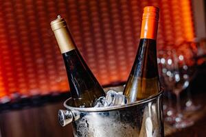 Chilled Elegance Two wine bottles nestled in a frosty ice bucket, reflecting a world of celebration and sophistication, ready to elevate the evening. photo