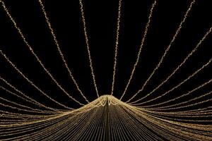 Radiant Orbs A Dance of String Lights in the Night - Delicate strands of warm light weave together in a mesmerizing radial pattern, illuminating the dark with enchanting luminosity. photo