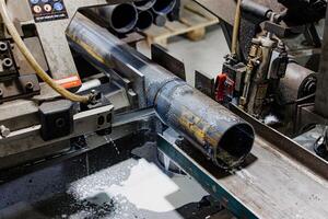 Precision in Motion A Spark of Engineering Efficiency as an Industrial Machine Grinds Through Steel Pipe photo