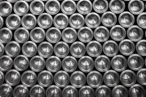 A vibrant tower of sleek aluminum cans glimmers under soft lighting, showcasing an array of colors that dance together. Each can, perfectly stacked photo