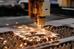 Precision Sparks A laser cutting machine meticulously crafts intricate designs on gleaming metal, transforming raw materials into stunning works of art with each focused beam. photo