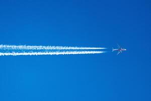 Skyward Journey A Lone Airplane Traces the Canvas of Clouds with Ethereal Contrails, Painting Dreams Across the Vast Blue Horizon. photo