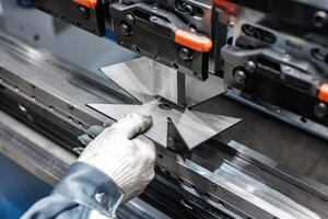 Precision in Motion A Skilled Operator Shapes Metal with State-of-the-Art Bending Machinery, Transforming Raw Sheets into Custom Creations. photo