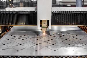 Precision in Motion A laser cutting machine seamlessly etches intricate patterns onto a gleaming metal sheet, illuminating innovation in the heart of modern engineering. photo