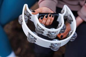 Vibrant Melody in Hand A Close-Up of a Tambourine, Capturing the Essence of Joyful Rhythm and Musical Expression. photo