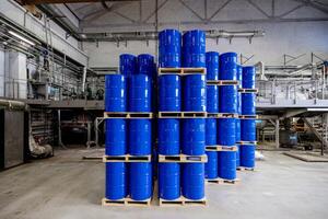 Stacked Horizons A Symphony of Blue Barrels in an Industrial Warehouse, Awaiting Purpose Amidst the Raw Aesthetics of Functionality. photo