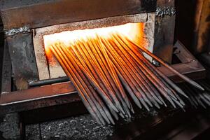 Forging Transformation Intense Heat Ignites Metal Rods in the Heart of the Furnace, Unleashing a Dance of Fire and Strength. photo