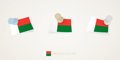 Pinned flag of Madagascar in different shapes with twisted corners. pushpins top view. vector