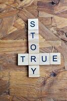 true story text on wooden square photo