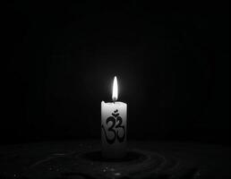 a candle with the word om written on it in black and white photo