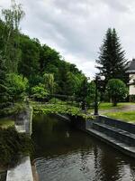 Tranquil garden with bridge over serene waterway photo