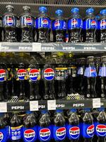 Kyiv, Ukraine - November 20, 2024 Rows of Pepsi bottles on supermarket shelf display photo