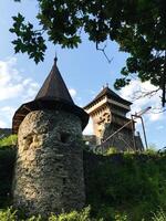 Ancient stone tower and fortress under clear blue sky. Nevytske, Transcarpathia, Ukraine. photo