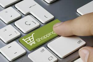 Finger hovers over green Shopping key, emphasizing online purchase action photo