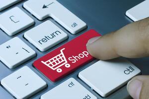Red Shop key on keyboard, finger hovering, ready for online shopping action photo